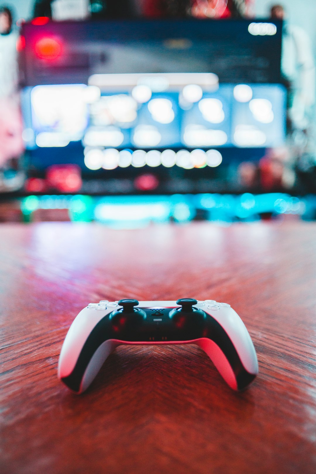 red-and-white-game-controller-on-brown-wooden-table-m5vk9nzsiba